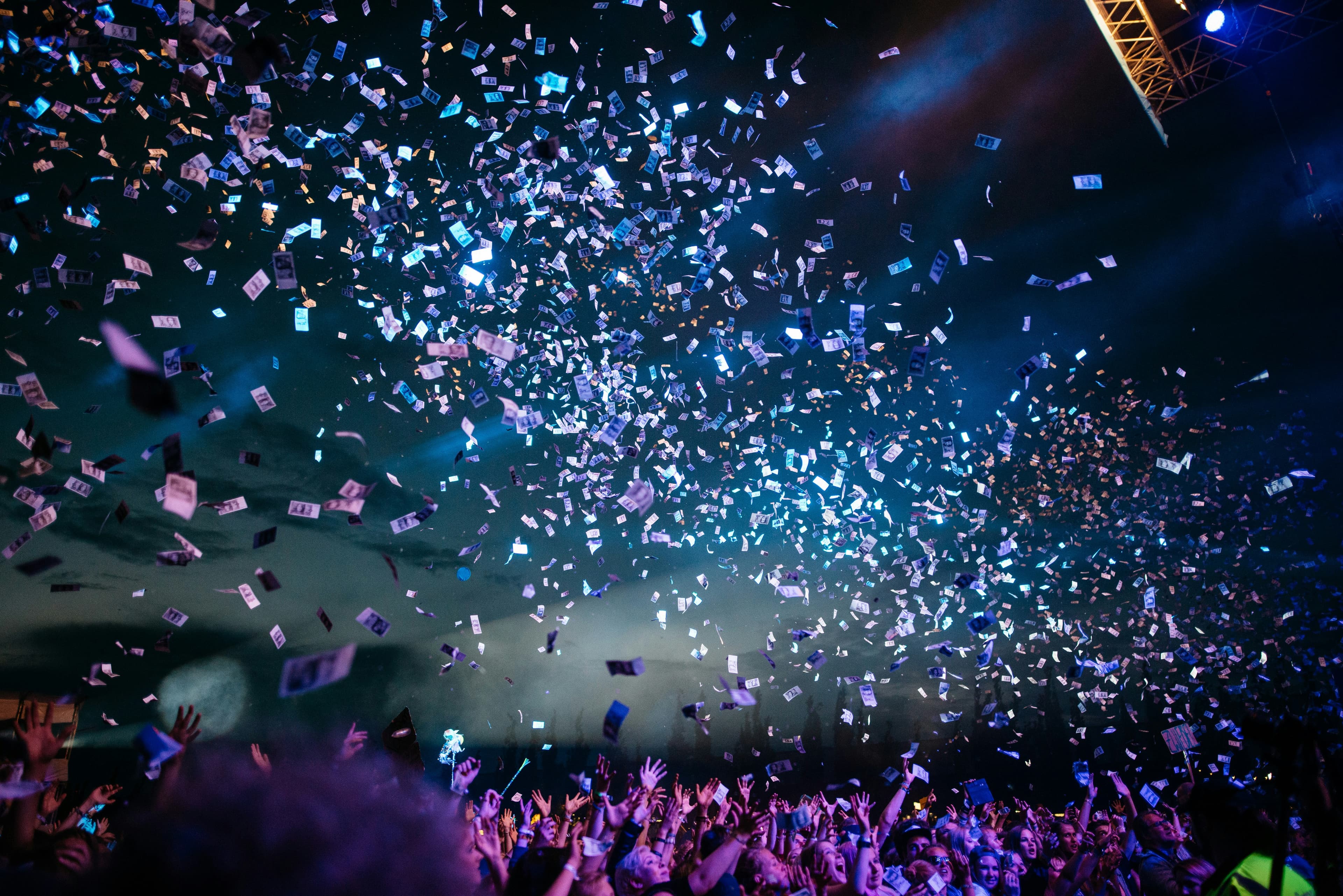 A lively event atmosphere with warm lighting and people gathered in celebration.