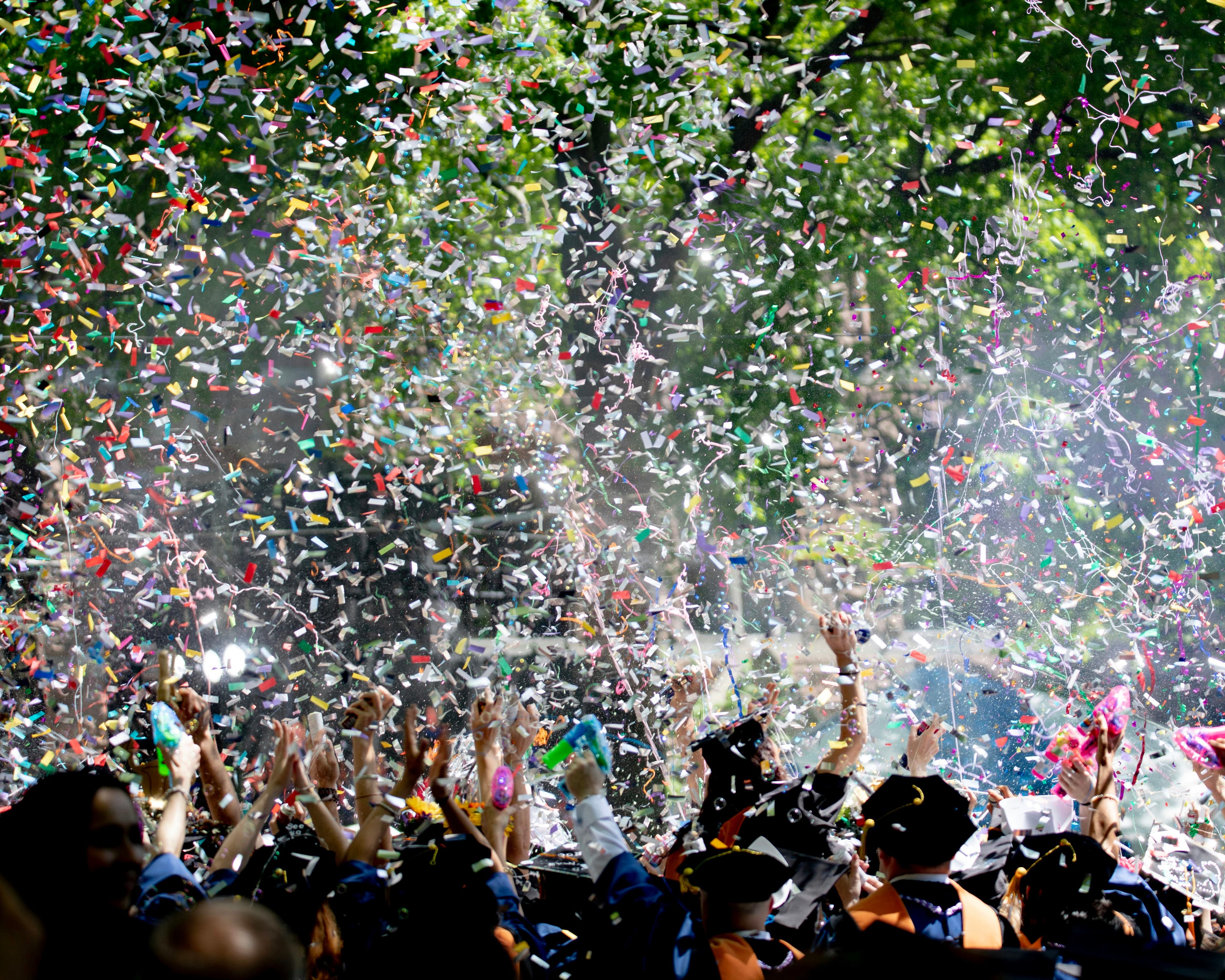 People celebrating together with confetti at a lively event, representing recognition and community achievement.
