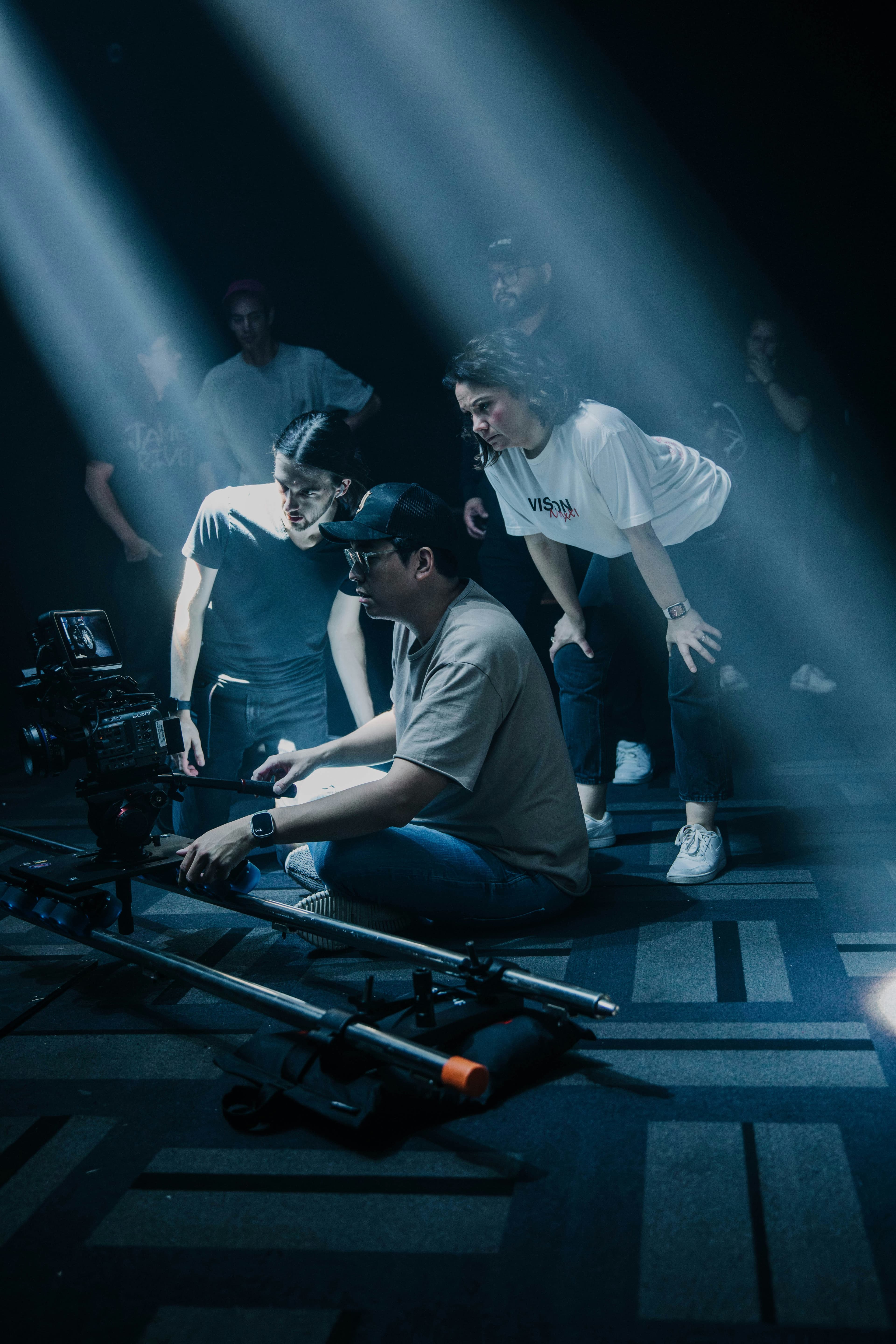 A group of creators collaborating around a camera on a film-style content shoot.